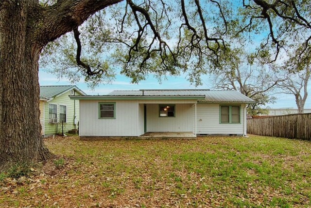 1116-C Simpson St, Schulenburg, TX 78956 - back of house with a lawn, metal roof, fence, and a patio