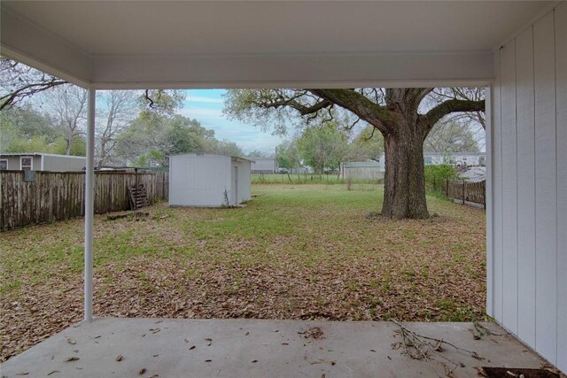 1116-C Simpson St, Schulenburg, TX 78956 - view of yard featuring a fenced backyard, a shed, an outbuilding, and a patio