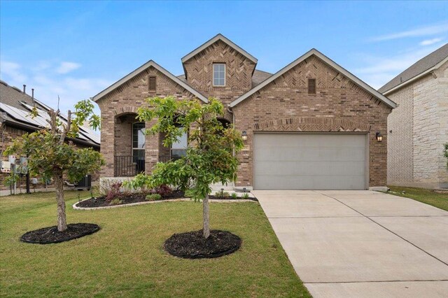 6725 Verona Pl, Round Rock, TX 78665 - traditional home with brick siding, concrete driveway, a garage, and a front yard