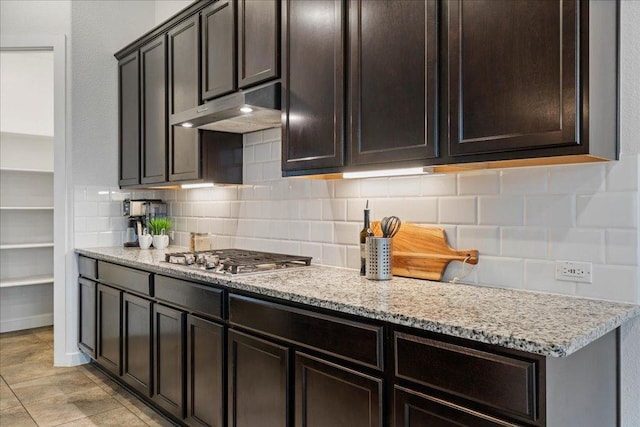 6725 Verona Pl, Round Rock, TX 78665 - kitchen featuring under cabinet range hood, stainless steel gas cooktop, tasteful backsplash, and light stone countertops