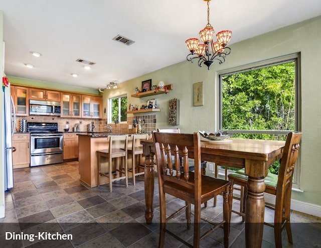 dining space with baseboards, visible vents, recessed lighting, and a notable chandelier