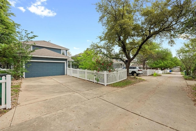 1012 Peyton Pl, Cedar Park, TX 78613 - view of home's exterior featuring a fenced front yard, a garage, concrete driveway, and roof with shingles