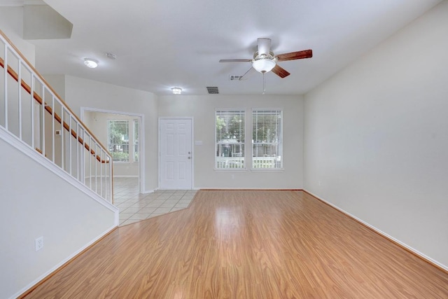 1012 Peyton Pl, Cedar Park, TX 78613 - foyer entrance with stairs, ceiling fan, wood finished floors, and baseboards
