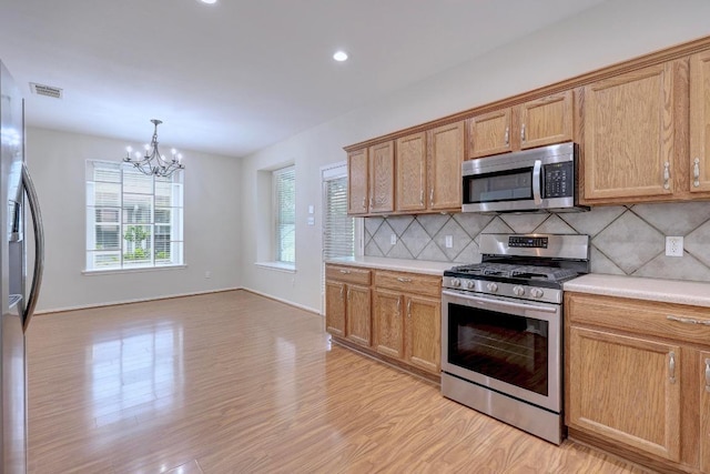 1012 Peyton Pl, Cedar Park, TX 78613 - kitchen featuring stainless steel appliances, light wood-style floors, decorative backsplash, light countertops, and recessed lighting
