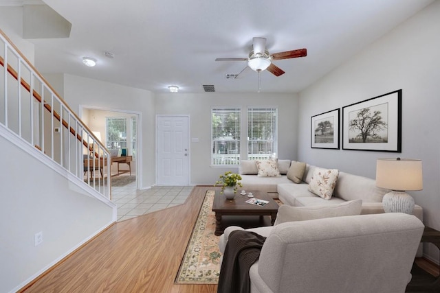 1012 Peyton Pl, Cedar Park, TX 78613 - living area featuring stairway, ceiling fan, plenty of natural light, and light wood-style flooring