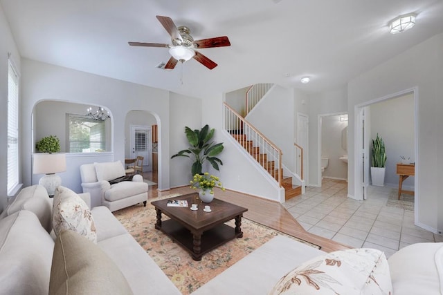 1012 Peyton Pl, Cedar Park, TX 78613 - living area featuring arched walkways, stairway, a ceiling fan, and a chandelier