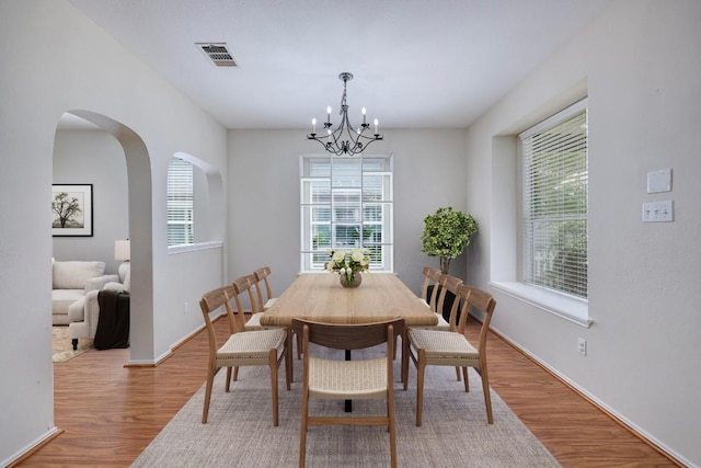 1012 Peyton Pl, Cedar Park, TX 78613 - dining area featuring a chandelier, wood finished floors, and arched walkways