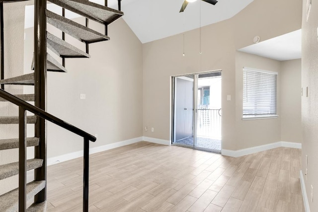 1840 Burton Dr Unit 167, Austin, TX 78741 - spare room with a ceiling fan, light wood finished floors, stairs, baseboards, and high vaulted ceiling