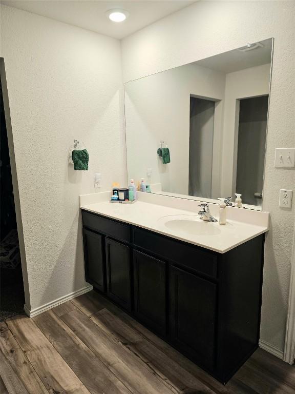 1124 Velvet Ct, Troy, TX 76579 - bathroom with vanity, a textured wall, and wood finished floors