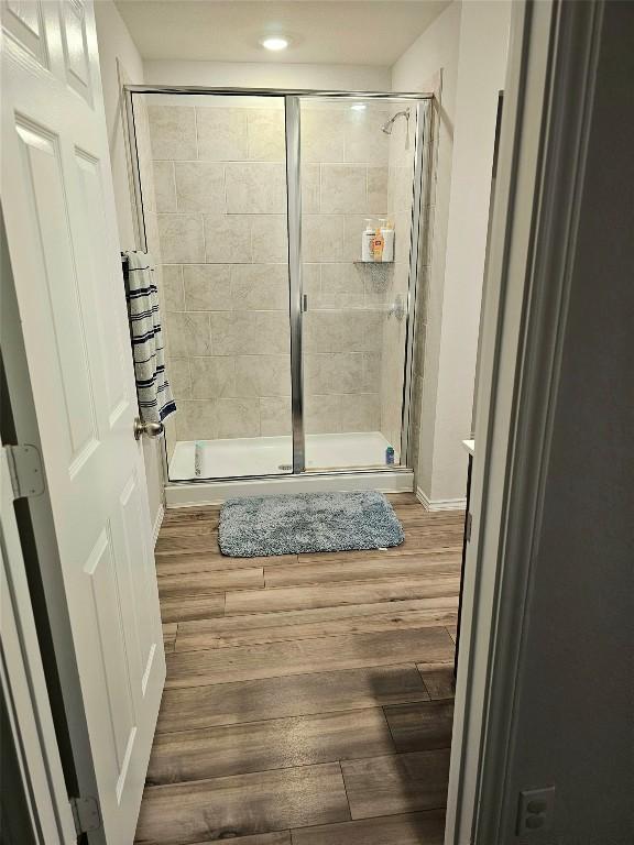 1124 Velvet Ct, Troy, TX 76579 - bathroom featuring a stall shower, wood finished floors, and recessed lighting