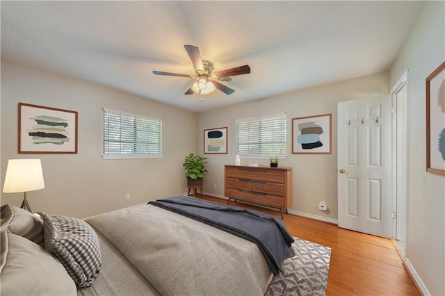 2004 Teakwood Dr, Austin, TX 78757 - bedroom featuring multiple windows, light wood-style floors, and ceiling fan