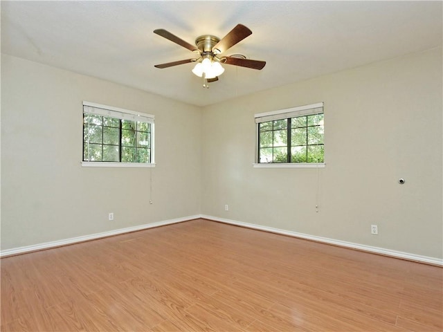 2004 Teakwood Dr, Austin, TX 78757 - empty room with plenty of natural light, light wood-style flooring, and a ceiling fan