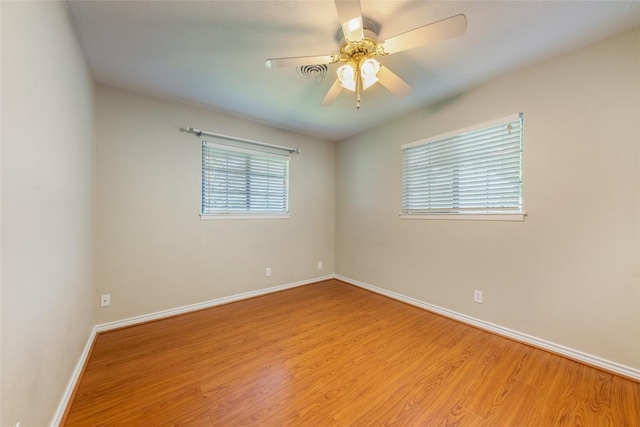 2004 Teakwood Dr, Austin, TX 78757 - spare room featuring wood finished floors and a ceiling fan