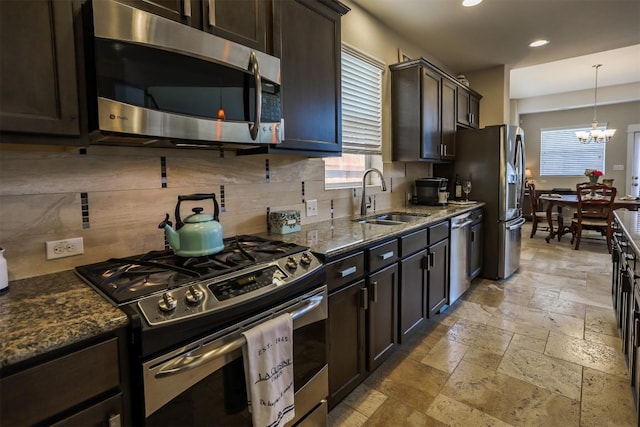11913 Natures Bnd, Austin, TX 78753 - kitchen featuring appliances with stainless steel finishes, plenty of natural light, stone tile flooring, decorative backsplash, and recessed lighting