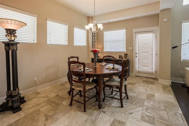 11913 Natures Bnd, Austin, TX 78753 - dining area featuring stone tile flooring and a chandelier