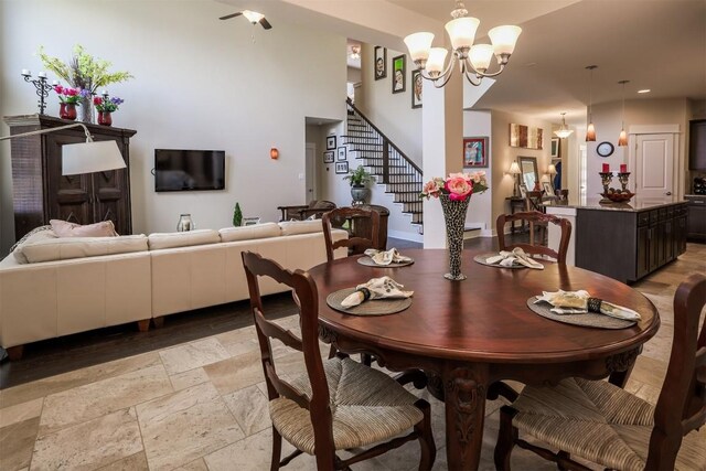 11913 Natures Bnd, Austin, TX 78753 - dining space featuring stairs, a chandelier, stone tile floors, and recessed lighting