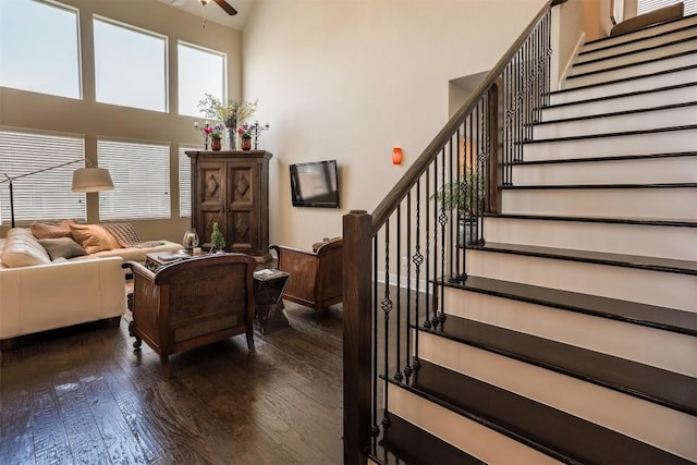 11913 Natures Bnd, Austin, TX 78753 - living room featuring dark wood-type flooring, stairs, a ceiling fan, and a towering ceiling