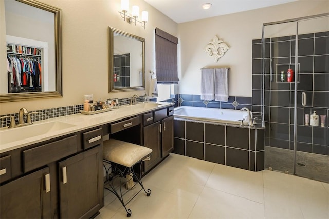 11913 Natures Bnd, Austin, TX 78753 - full bath featuring double vanity, a garden tub, tile patterned flooring, and a tile shower