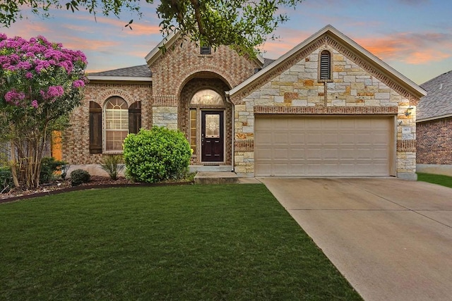 1411 Rowan Dr, Georgetown, TX 78628 - french country home with driveway, a garage, a lawn, and stone siding