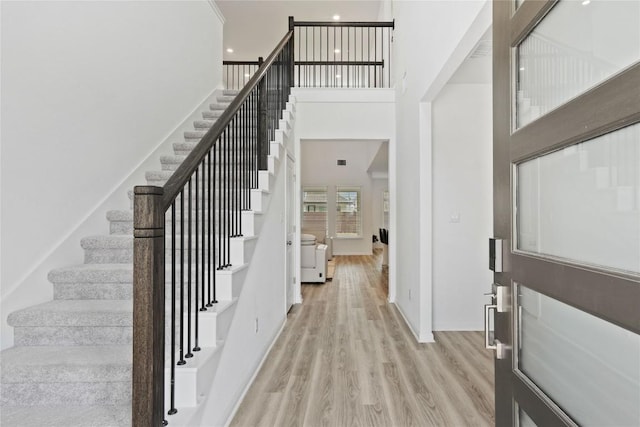 708 Leeward Pass, Leander, TX 78641 - foyer with stairway, a towering ceiling, light wood-style floors, and recessed lighting