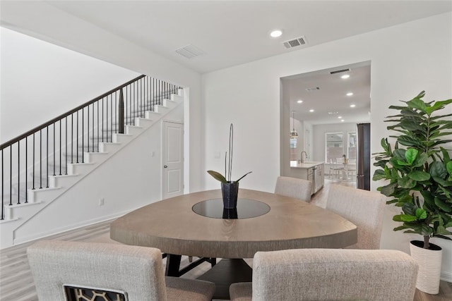 708 Leeward Pass, Leander, TX 78641 - dining room with wood finished floors, stairs, and recessed lighting