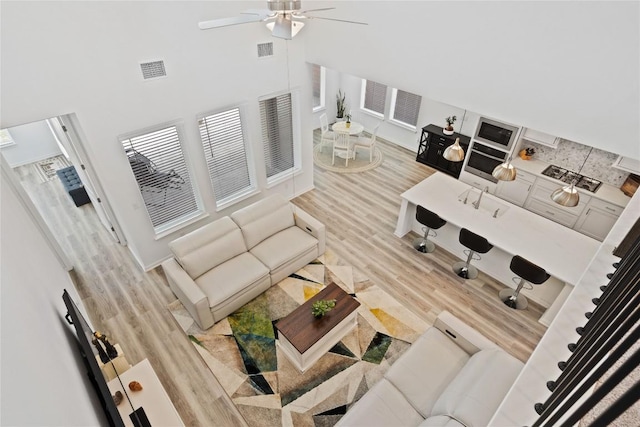 708 Leeward Pass, Leander, TX 78641 - living area with ceiling fan and wood finished floors