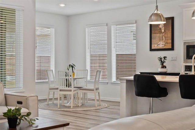 708 Leeward Pass, Leander, TX 78641 - dining space with light wood-style flooring and baseboards