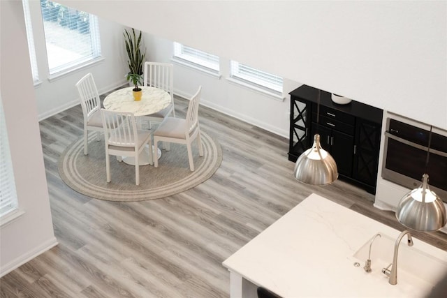 708 Leeward Pass, Leander, TX 78641 - dining room featuring wood finished floors and plenty of natural light