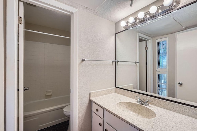 1510 W N Loop Blvd Unit 1024, Austin, TX 78756 - full bathroom with vanity, toilet, a textured wall, shower / bathtub combination, and tile patterned floors