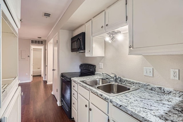 1510 W N Loop Blvd Unit 1024, Austin, TX 78756 - kitchen featuring black appliances, a sink, dark wood-type flooring, white cabinetry, and light countertops