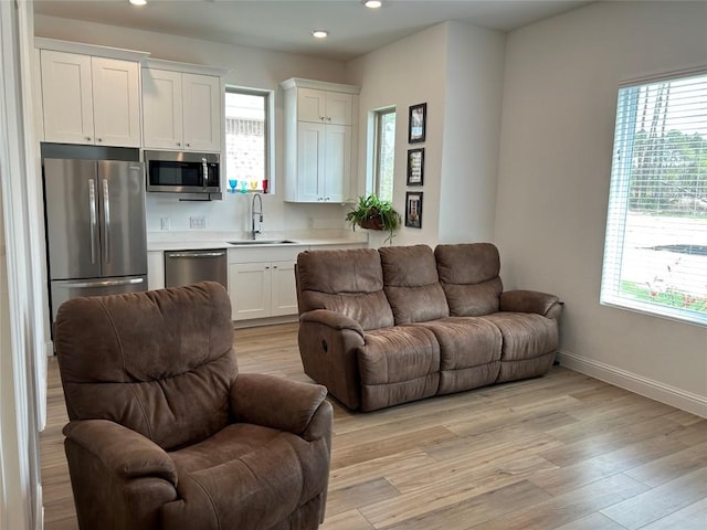 22046 Gateway Arch Dr, Porter, TX 77365 - living area featuring recessed lighting, healthy amount of natural light, and light wood finished floors