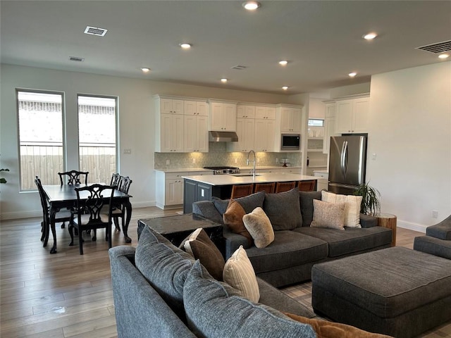 22046 Gateway Arch Dr, Porter, TX 77365 - living room with baseboards, healthy amount of natural light, recessed lighting, and light wood-style flooring