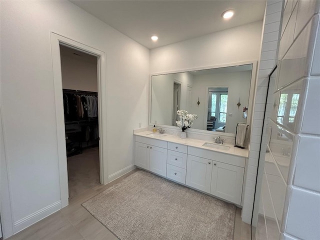 22046 Gateway Arch Dr, Porter, TX 77365 - full bath with double vanity, recessed lighting, a spacious closet, and baseboards