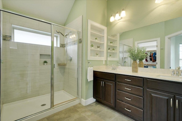 bathroom with a healthy amount of sunlight, a sink, and a stall shower