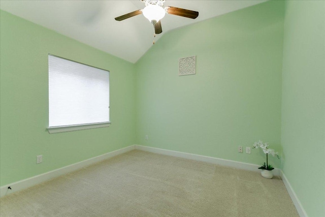 spare room featuring ceiling fan, light carpet, baseboards, and lofted ceiling