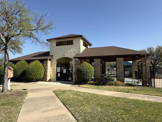 536 Loma Cedro Bnd, Leander, TX 78641 - view of front of house with stucco siding, roof with shingles, and a gate