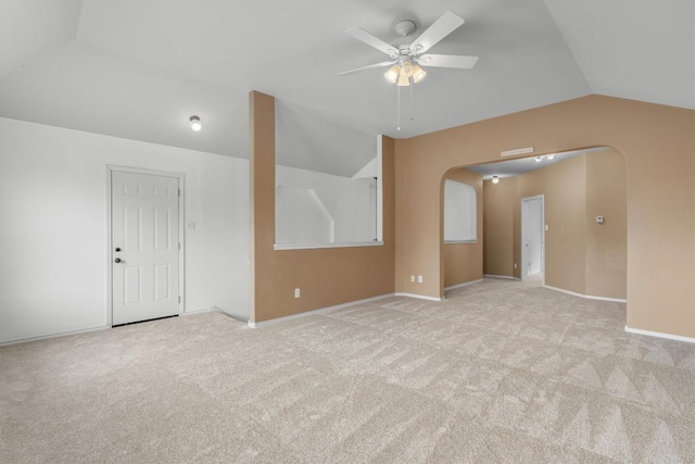 spare room with ceiling fan, carpet flooring, and vaulted ceiling