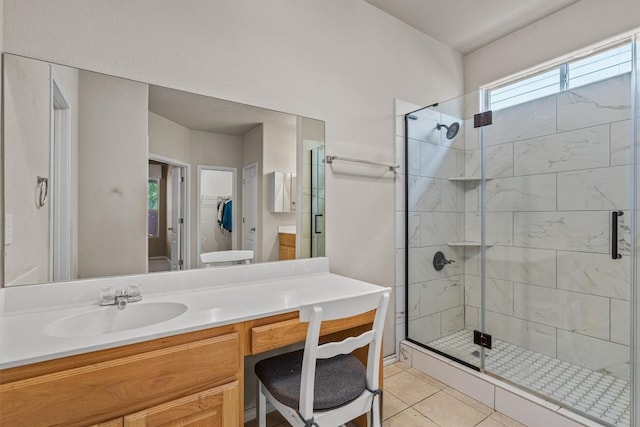 full bathroom with tile patterned floors, a stall shower, and vanity
