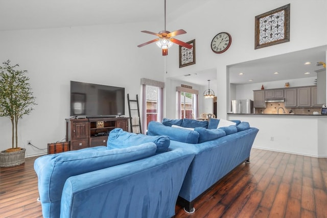 living room featuring dark wood-style floors, a ceiling fan, high vaulted ceiling, and recessed lighting
