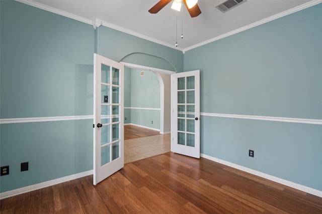 318 Ridge Run Dr, Georgetown, TX 78628 - empty room with french doors, wood finished floors, baseboards, a ceiling fan, and crown molding