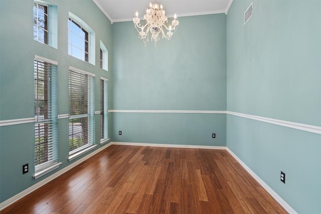 318 Ridge Run Dr, Georgetown, TX 78628 - unfurnished dining area featuring a chandelier, wood finished floors, healthy amount of natural light, baseboards, and crown molding