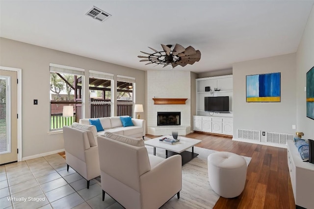 318 Ridge Run Dr, Georgetown, TX 78628 - living room with baseboards, a brick fireplace, and a ceiling fan