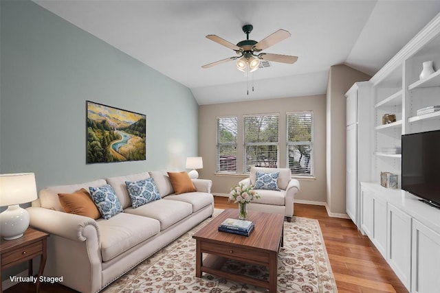 318 Ridge Run Dr, Georgetown, TX 78628 - living area featuring lofted ceiling, a ceiling fan, light wood-type flooring, and baseboards