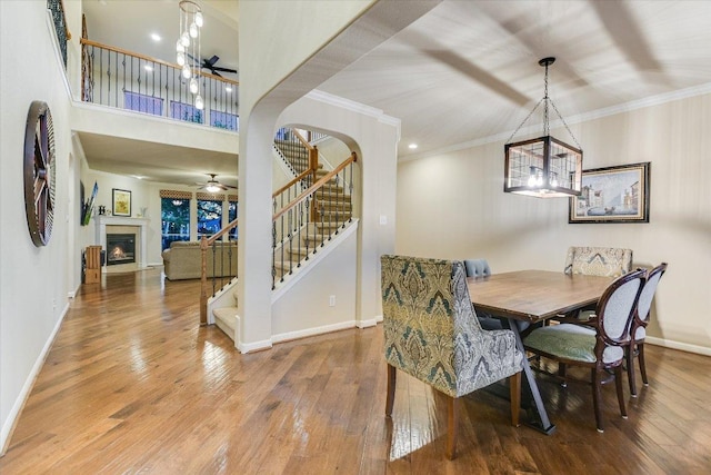 431 Ridgetop Bnd, Cedar Park, TX 78613 - dining space with a chandelier, stairs, hardwood / wood-style flooring, ceiling fan, and crown molding