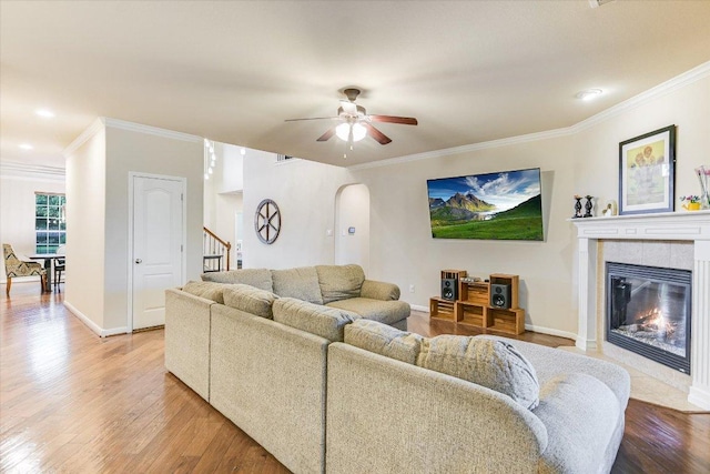 431 Ridgetop Bnd, Cedar Park, TX 78613 - living area with arched walkways, light wood-style flooring, ornamental molding, stairway, and a ceiling fan