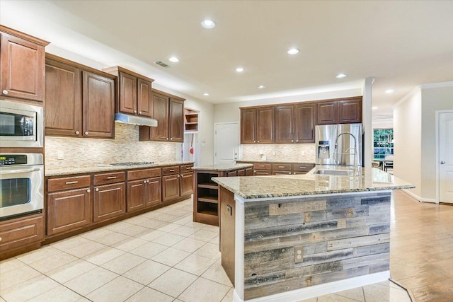 431 Ridgetop Bnd, Cedar Park, TX 78613 - kitchen featuring appliances with stainless steel finishes, open shelves, a large island, ornamental molding, and decorative backsplash