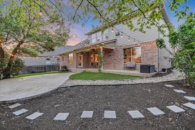 431 Ridgetop Bnd, Cedar Park, TX 78613 - back of property at dusk with brick siding and a patio