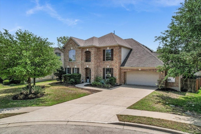 431 Ridgetop Bnd, Cedar Park, TX 78613 - view of front of home with brick siding, a garage, a front lawn, driveway, and a shingled roof
