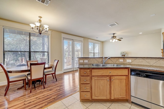 kitchen featuring dishwasher, visible vents, a sink, and light tile patterned flooring