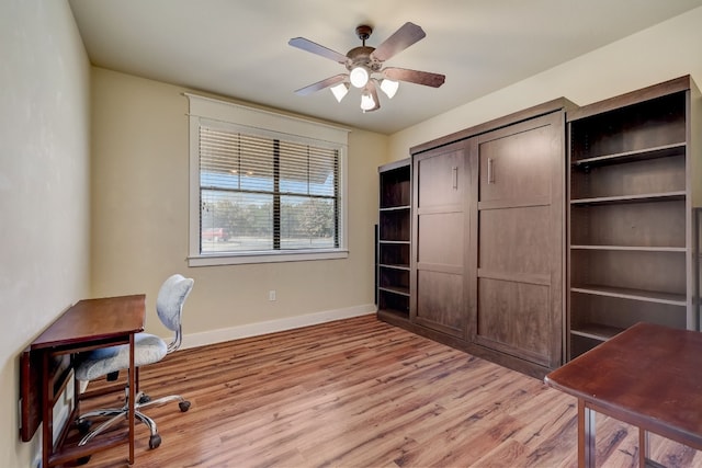 office space featuring light wood-style flooring, baseboards, and ceiling fan